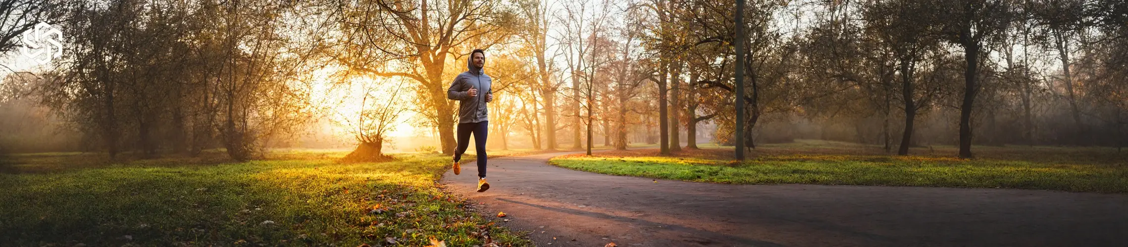 Man jogging outdoors at sunrise representing wellness and active lifestyle goals