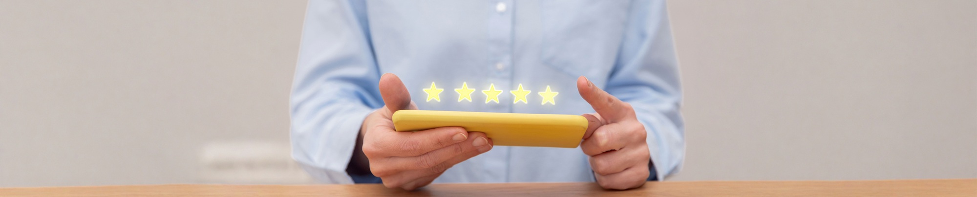 Close up of customer hands giving five star feedback on mobile phone for excellent customer service